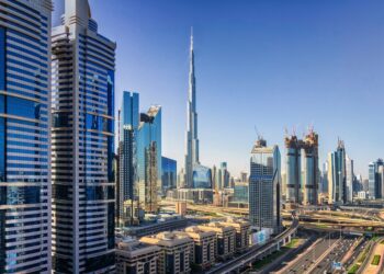 Sunny cityscape of Dubai under a blue sky