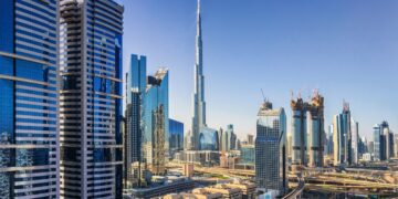 Sunny cityscape of Dubai under a blue sky