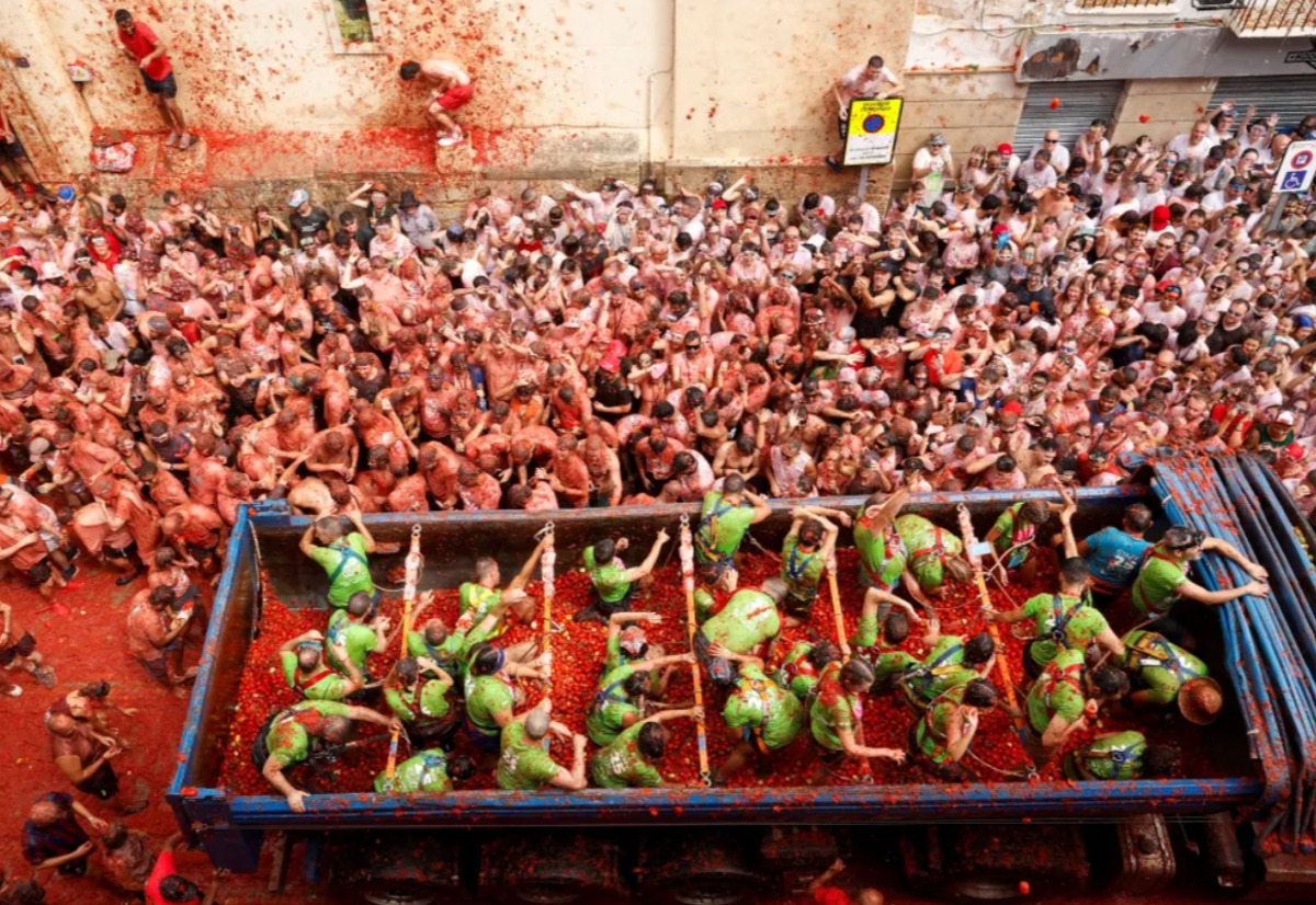 La Tomatina trucks dumping tomatoes street